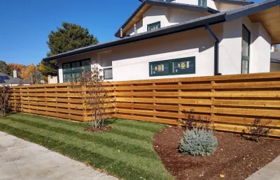 Cedar privacy fence installation with clean horizontal boards