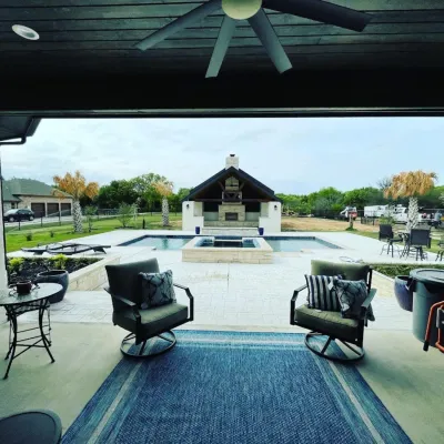 Covered patio overlooking pool and outdoor living area