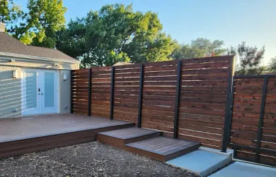 Backyard deck with horizontal wooden fence and steel frame gate