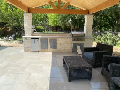 Outdoor kitchen with relaxation area and couch seating